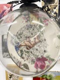 <p>Self portrait embroidery encased in glass sphere and iron support (1997)</p>
